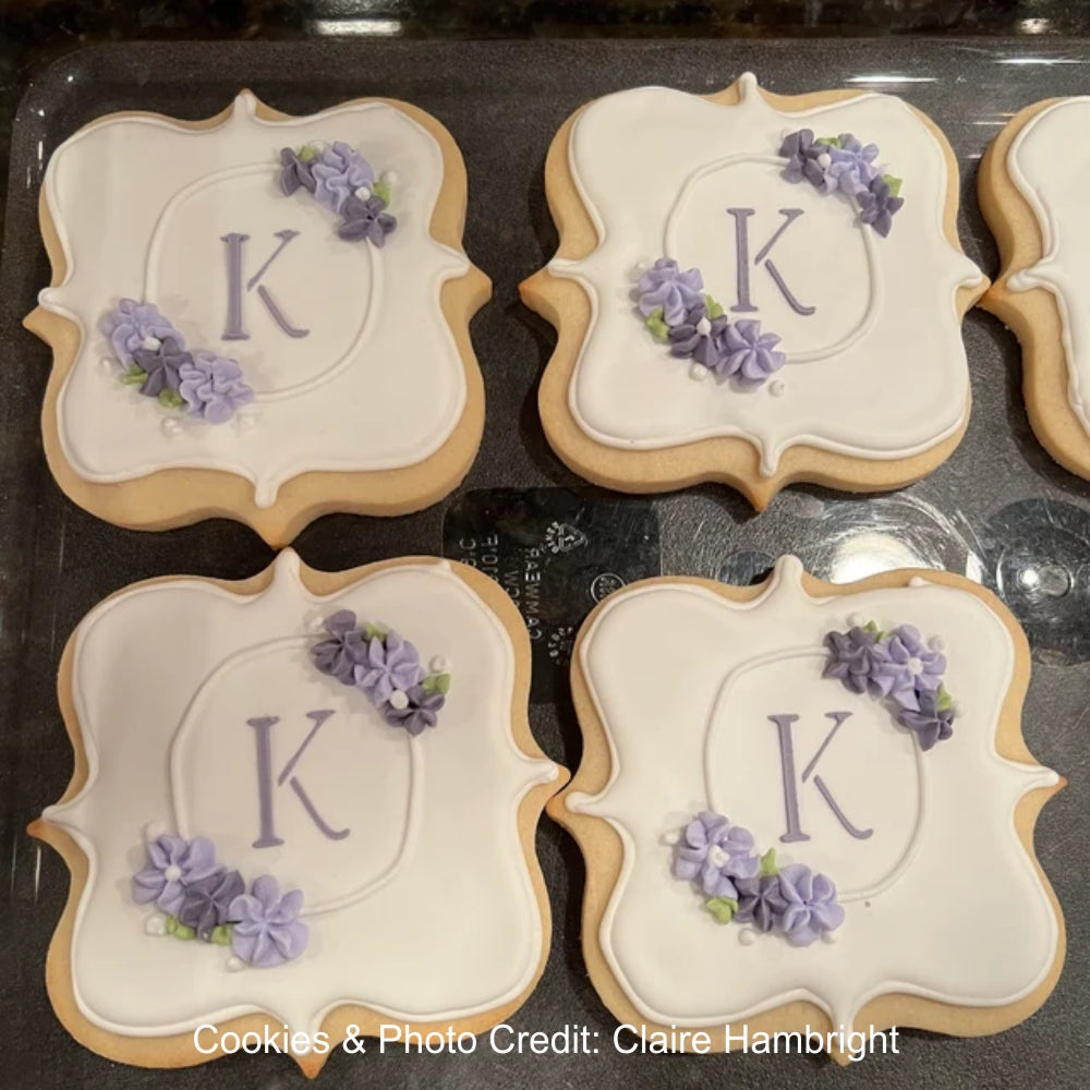 Cookies by Claire Hambright iced with a monogrammed K using the Simple Script Alphabet Cookie Stencil