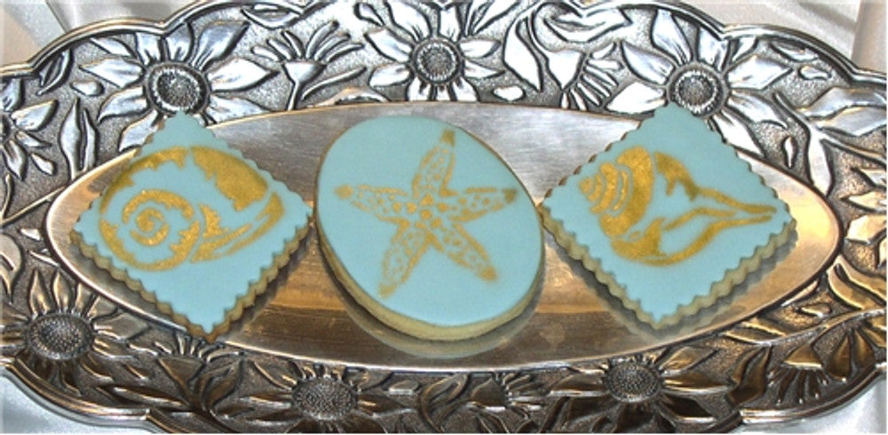 Cookies stenciled with the Shells Round Cookie Stencil Set by Designer Stencils